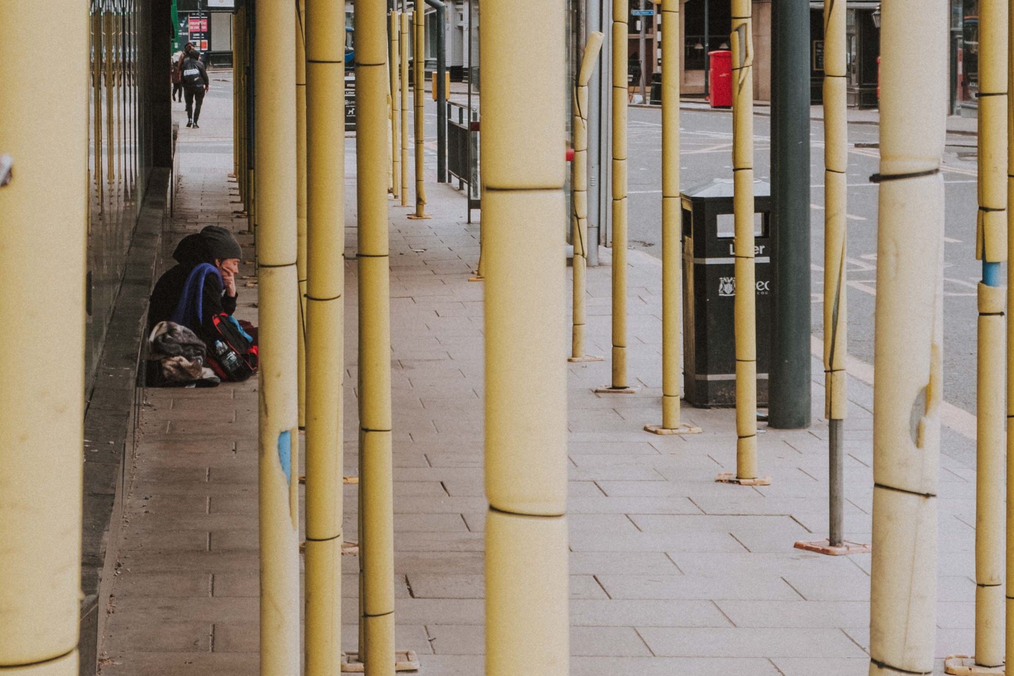 A homeless person sitting on the street in Leeds. Photo credit: Unsplash.